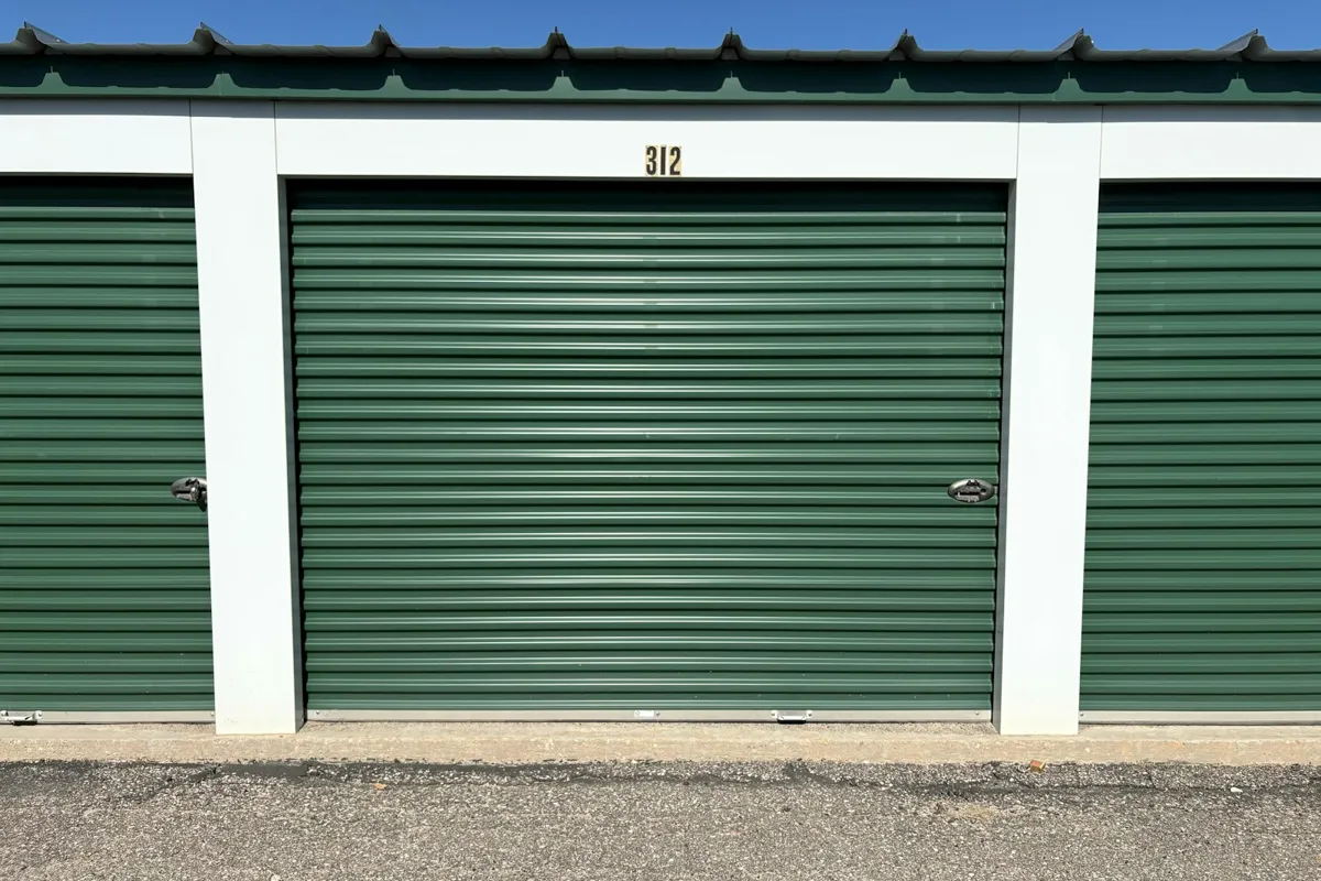 Green roll-up doors on a storage building