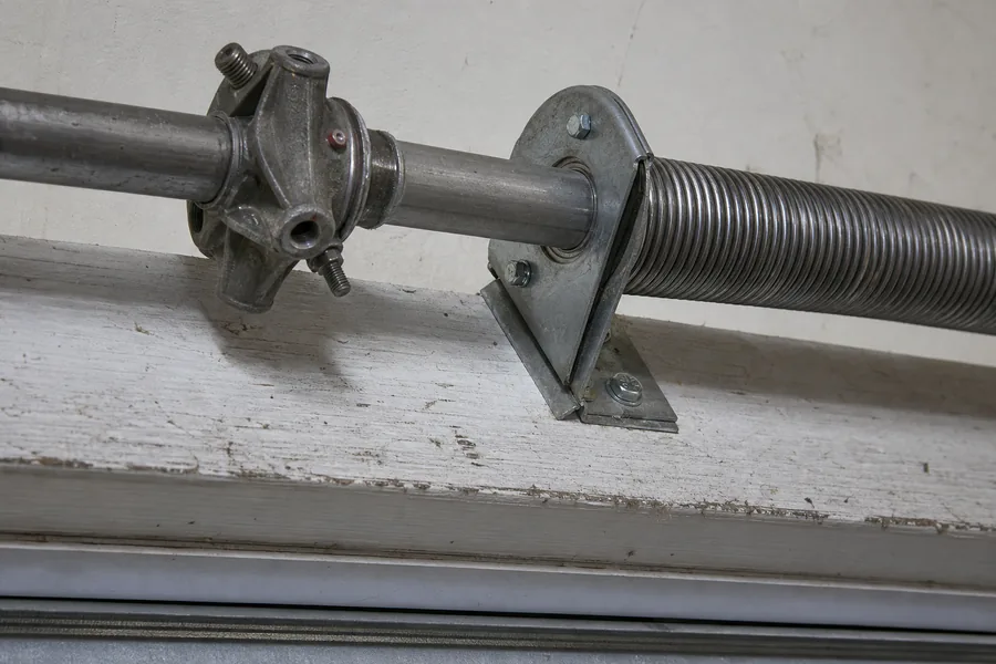 Torsion spring, winding cone and center bearing above a garage door in Rockford, IL